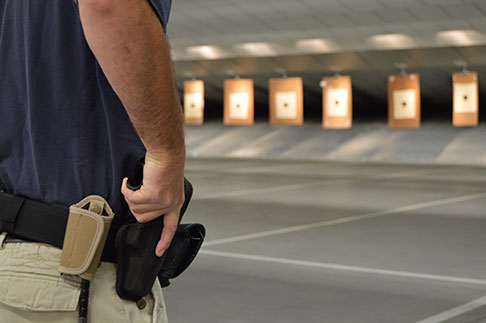 Image of trainee with hand on hand gun